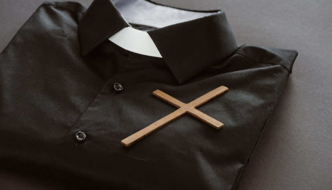 close-up shot of clerical shirt with cross on grey surface
