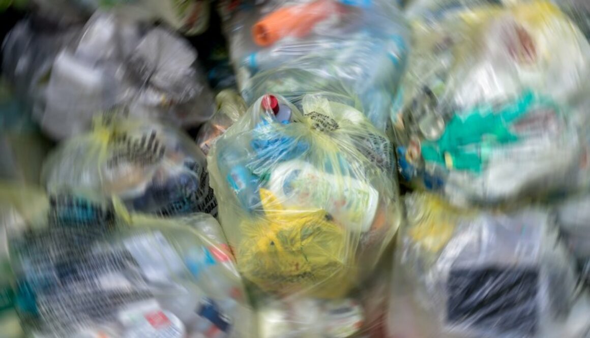 Close Up of garbage and waste in transparent bags. Radial blur effect.
